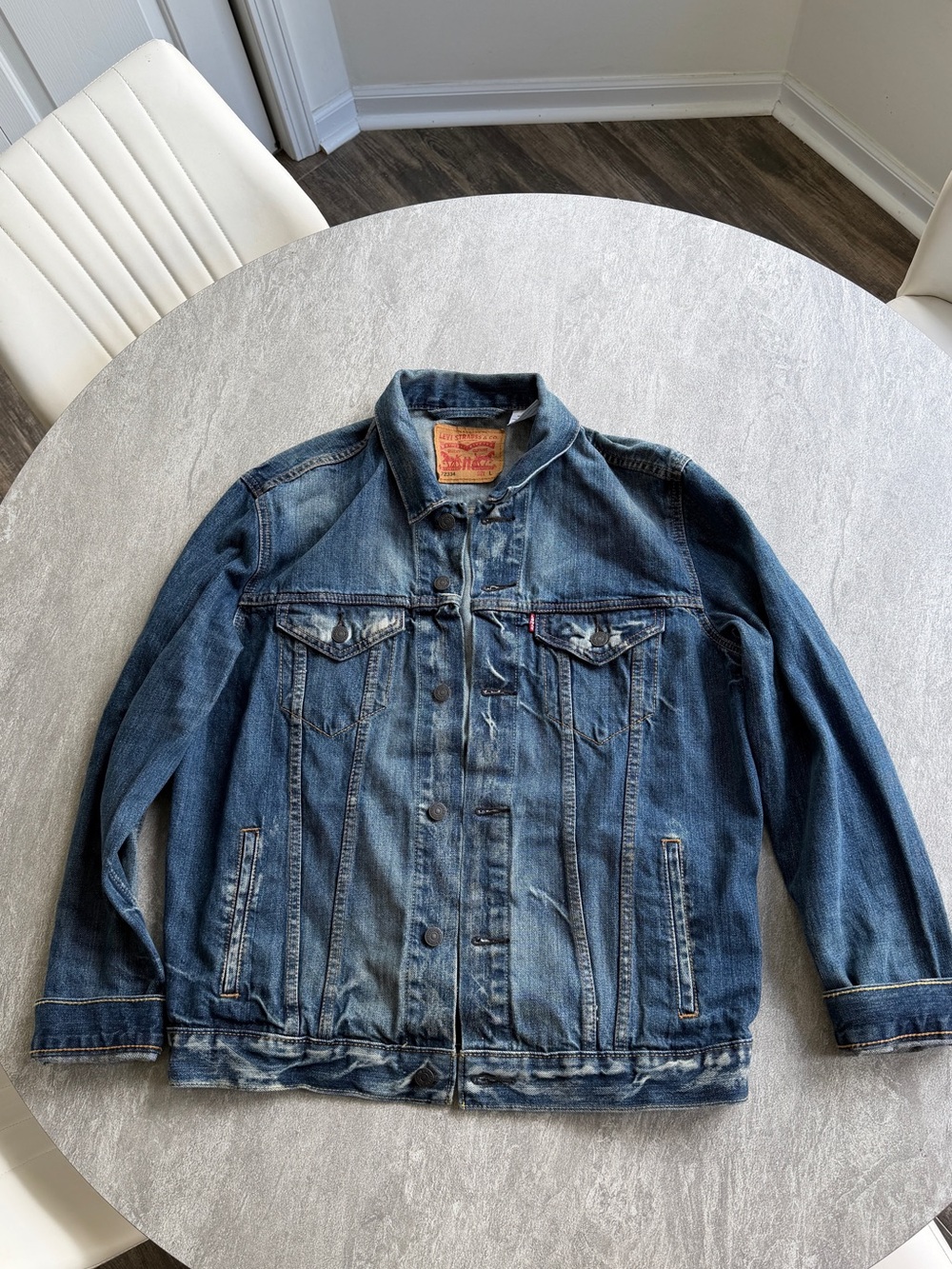 Levi's blue denim trucker jacket featuring a faded, distressed wash sz large